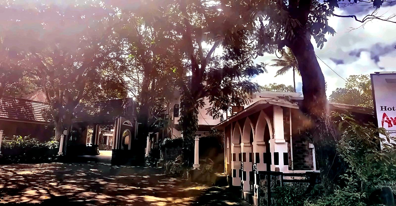 Hotel Ambadi entrance pavilion with heritage stone columns Thekkady