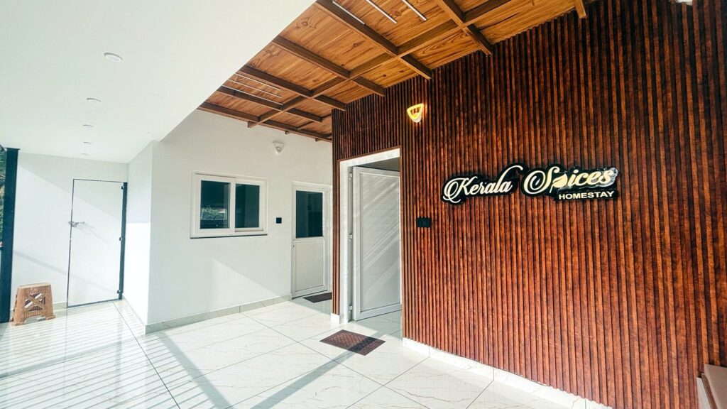 Kerala Spices Homestay entrance lobby with wooden signage