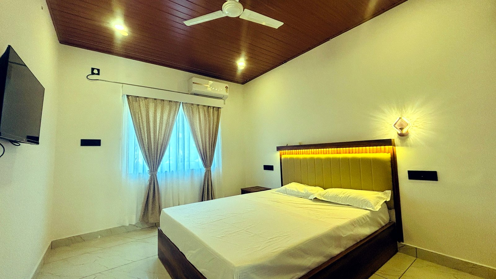Kerala Spices Homestay room interior with wooden ceiling and modern furniture